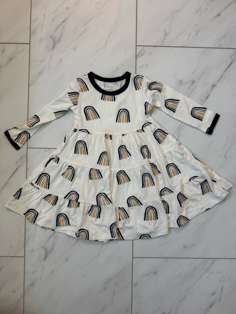 Kyte BABY White Dress with Black Trim and Mustard Rainbow Print